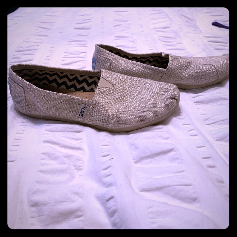 Like new, gold TOMS original slip ons